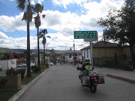 woman on motorcycle entering Tecate, Mexico